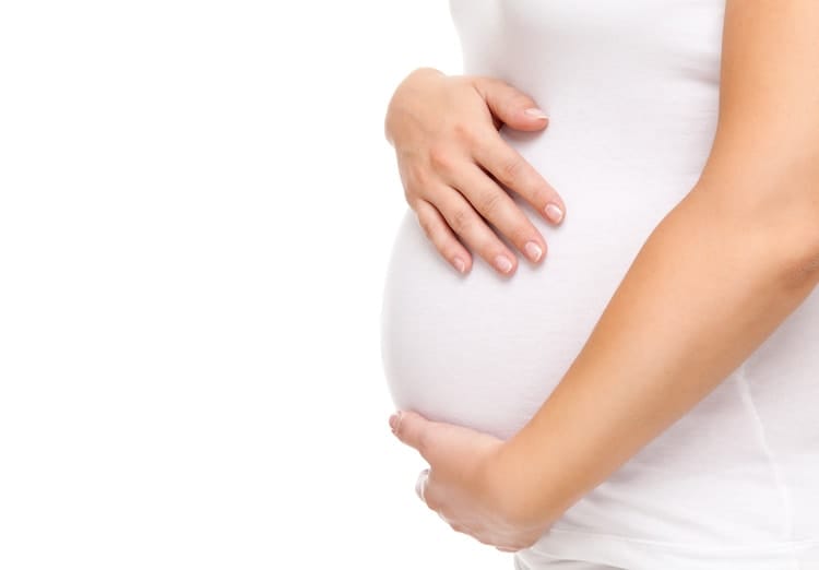Woman holding stomach, concerned about STDs and Pregnancy.