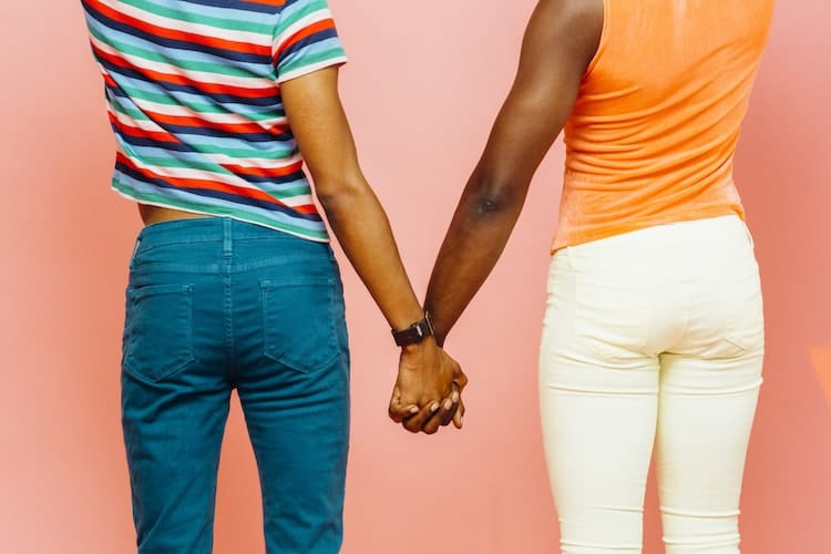 An endearing gay couple holding hands.