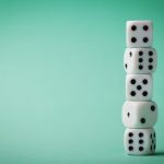 Photo of dice on bright green background.