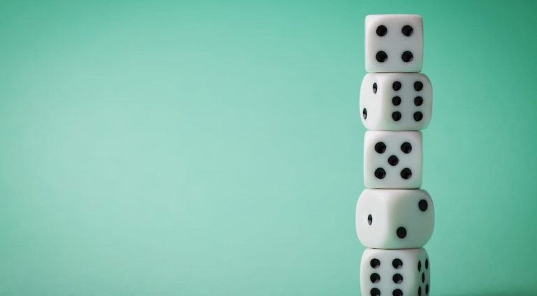 Photo of dice on bright green background.