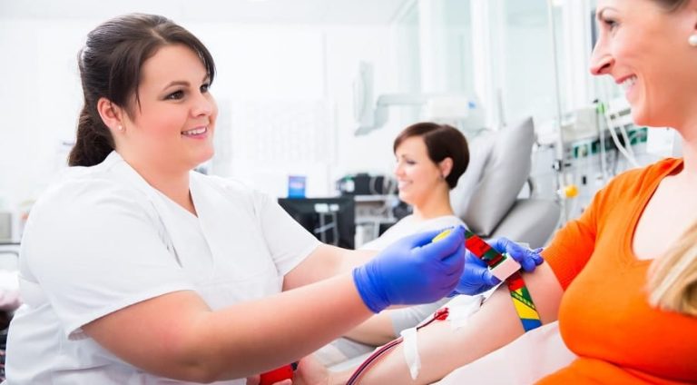 Nurse disinfecting puncture point before blood donation