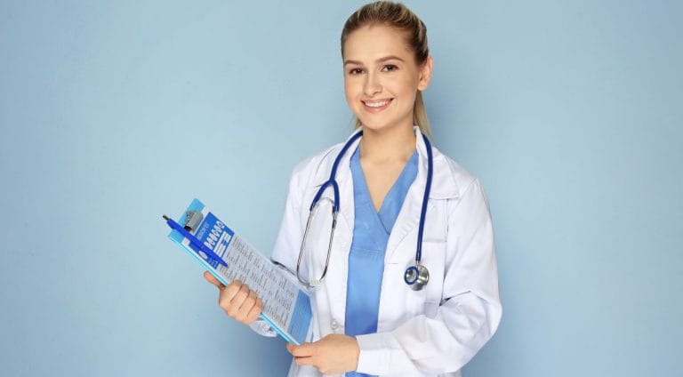 Female doctor with clipboard on color background